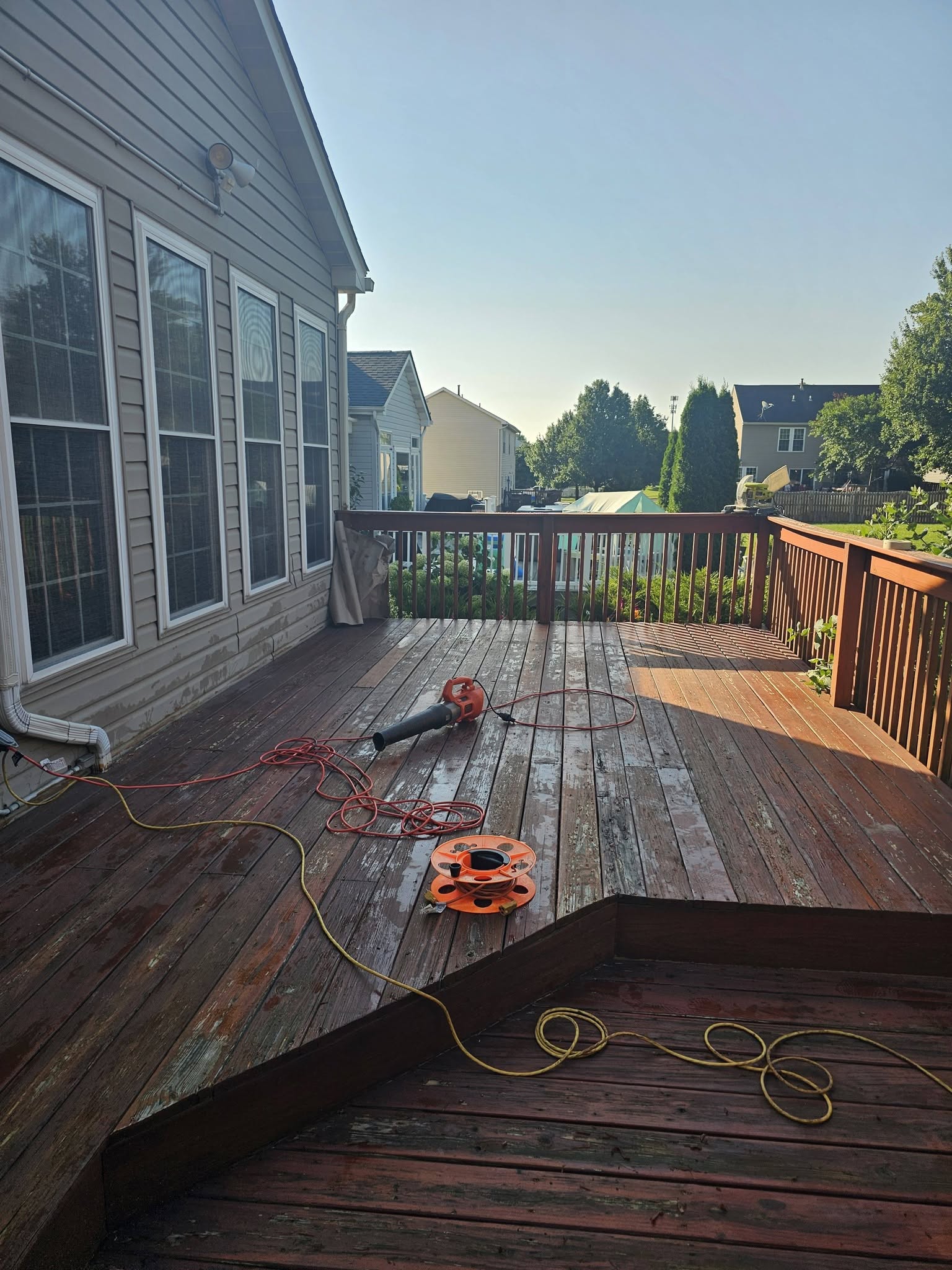 Weathered wood deck being cleaned and prepped for restaining